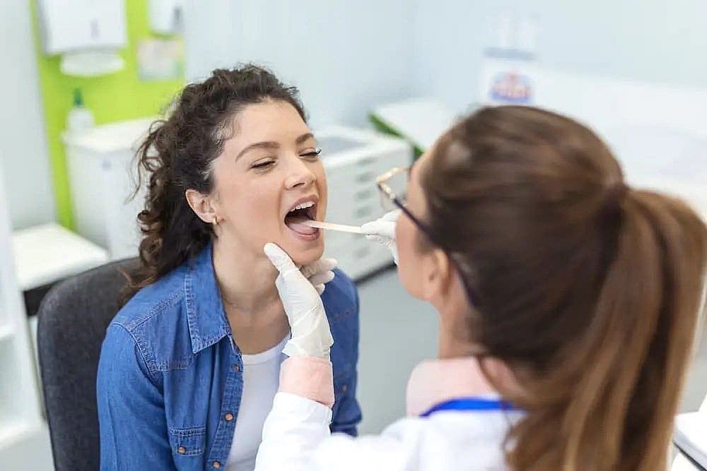 a woman getting her throat examined Underbite Treatment in Prosper or Colleyville, TX