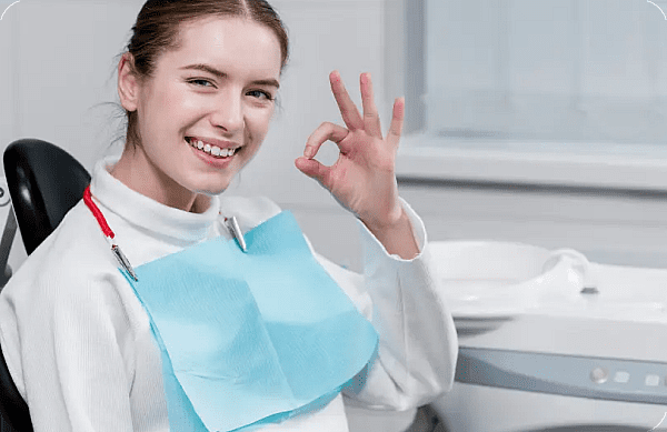 a woman smiling and giving a okay sign when Overbite Treatment in Prosper or Colleyville, TX