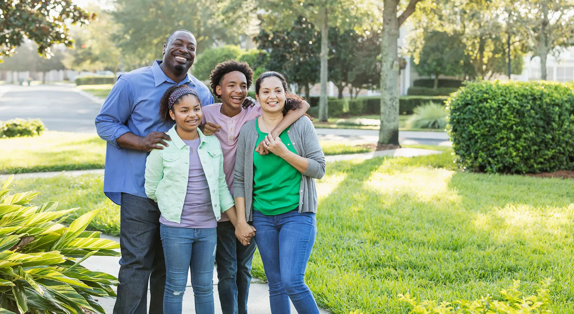 A happy family with children and adults sharing a bright, confident smile, representing affordable orthodontic care in Prosper and Colleyville, TX.