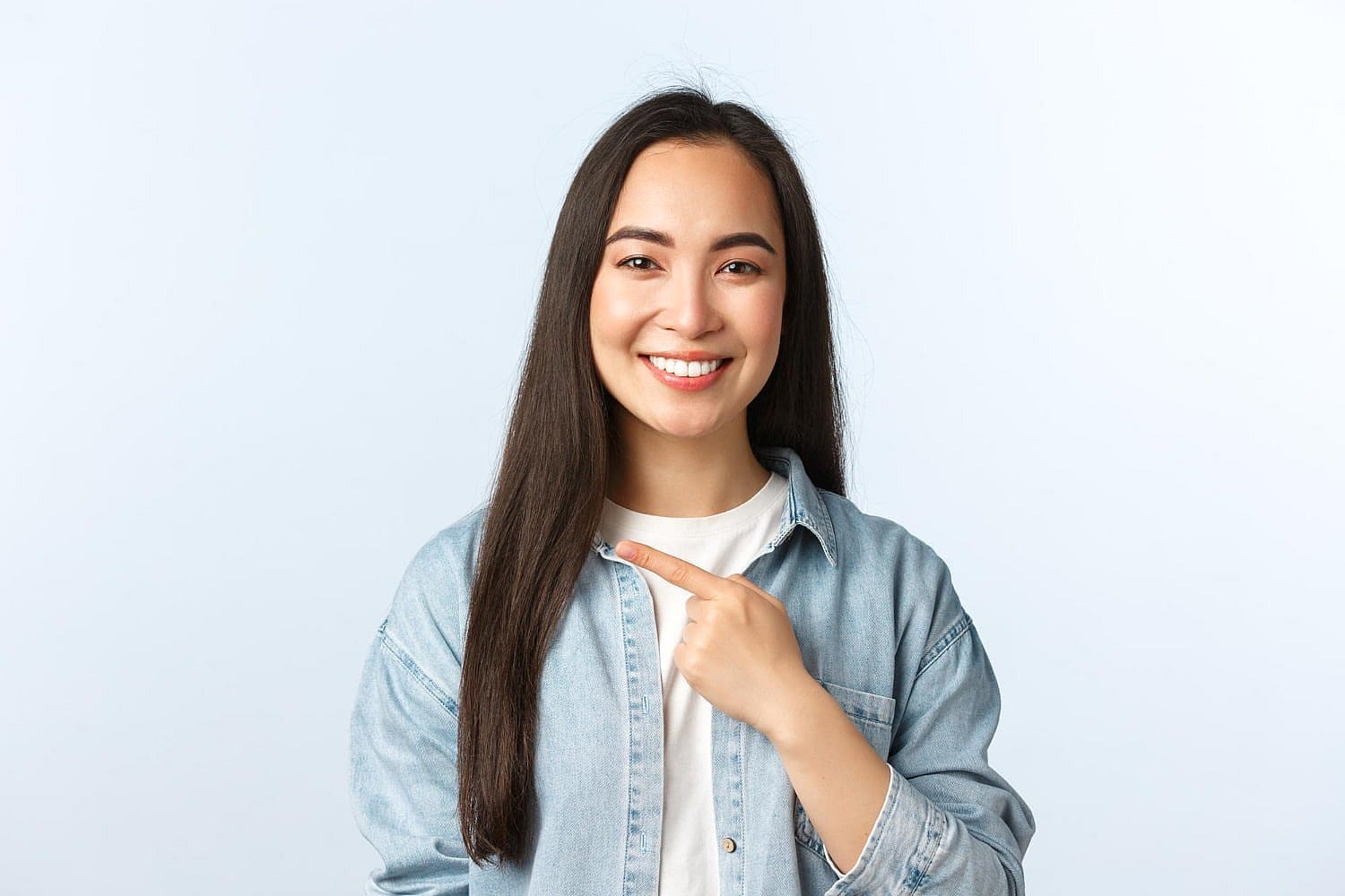 Smiling person with long hair, having treatment of overbite at Wink Orthodontics in Prosper or Colleyville, TX.