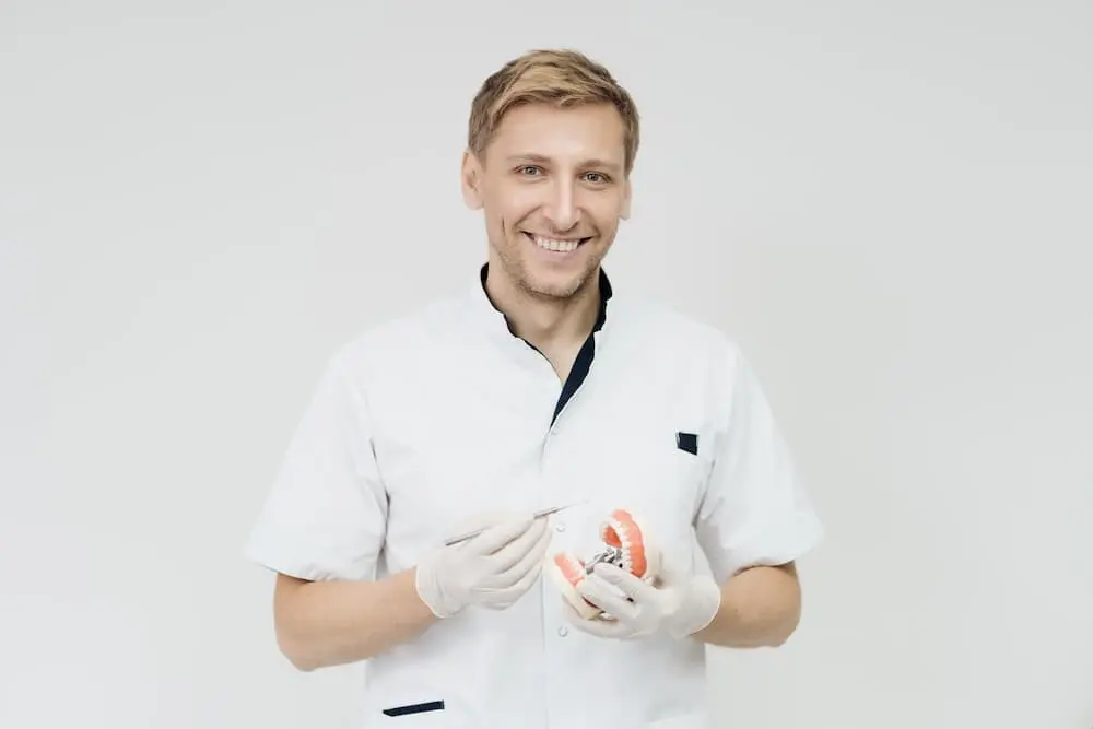 an Orthodontist in Prosper, TX holding a teeth model 